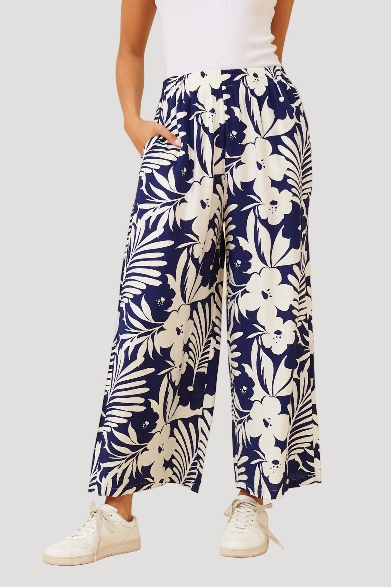 Navy blue floral patterned pants worn by a person