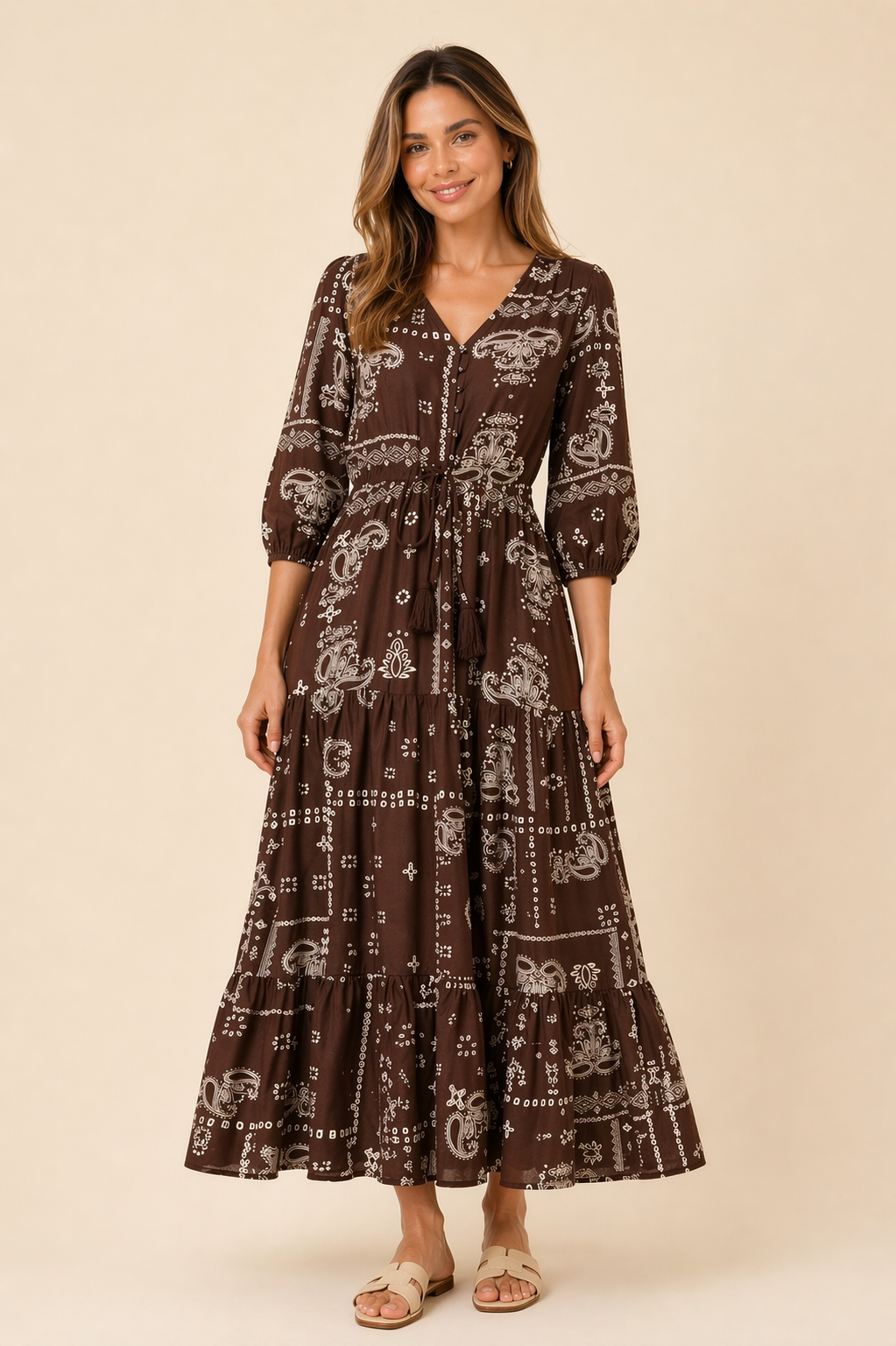 Woman wearing a brown patterned dress against a beige background