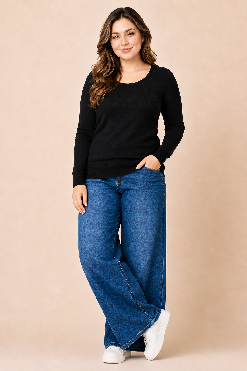 Woman wearing a black sweater and blue jeans against a beige background
