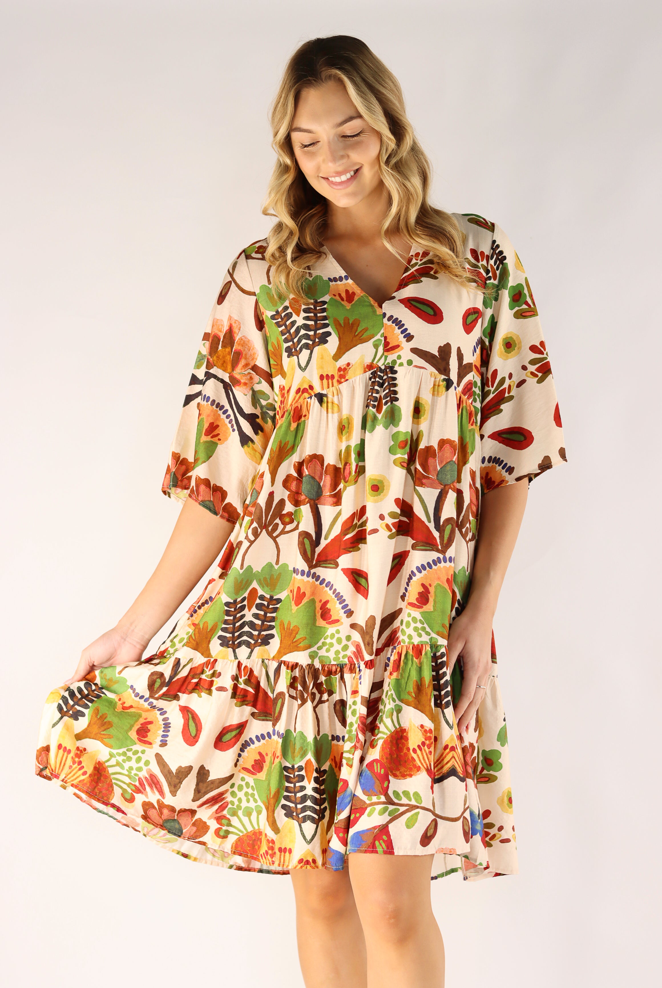 Woman wearing a colorful patterned dress on a white background