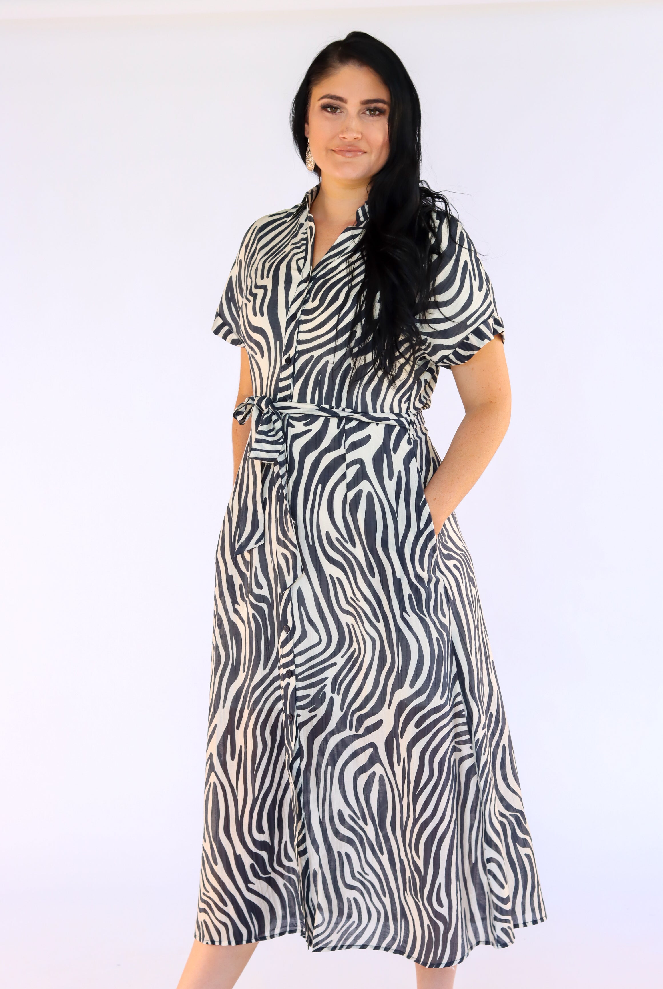 Woman wearing a zebra print dress on a white background