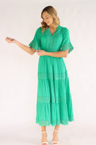 Woman wearing a green dress with half sleeves