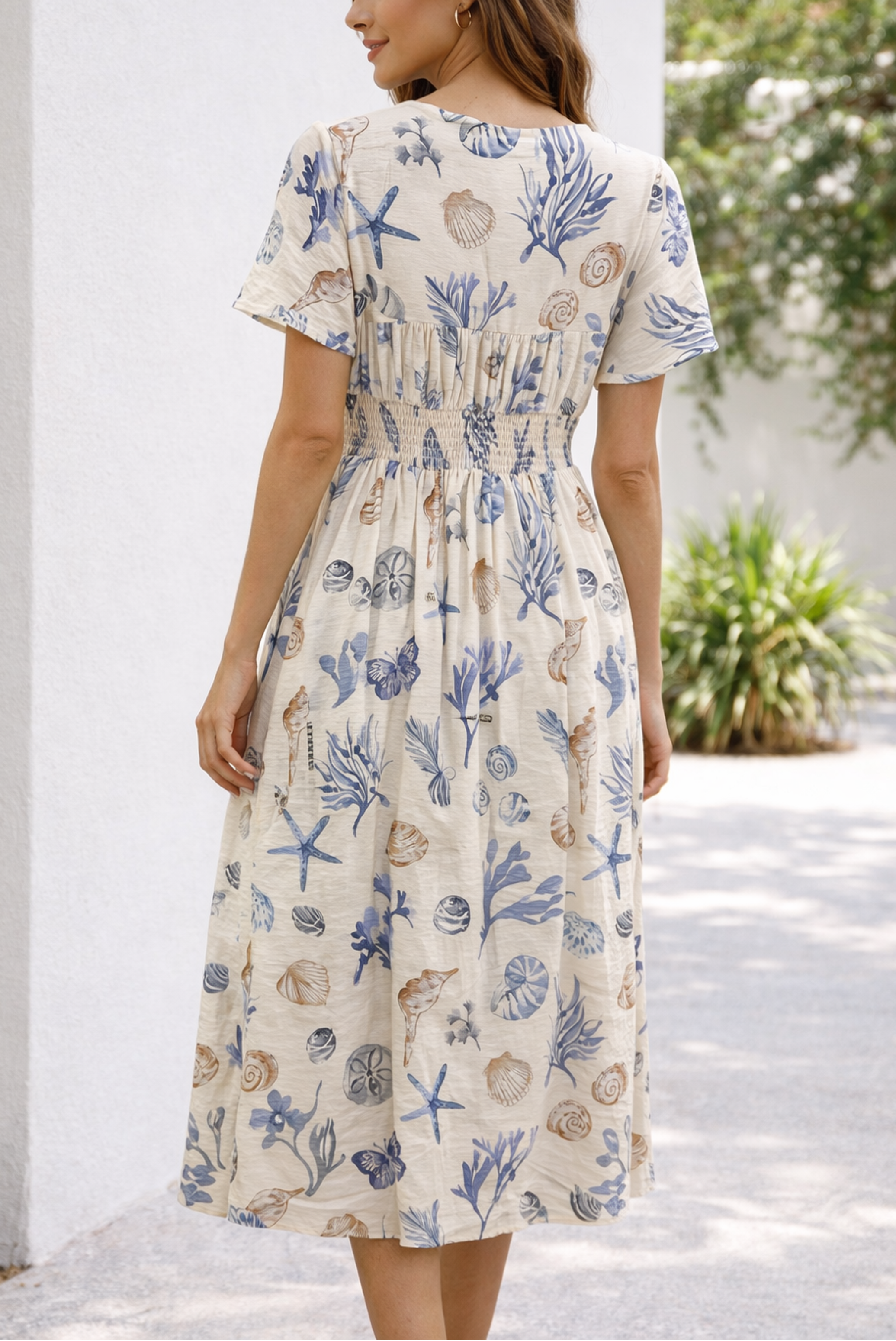 Woman wearing a floral dress with a backside pic