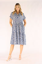 Woman wearing a blue patterned dress on a white background